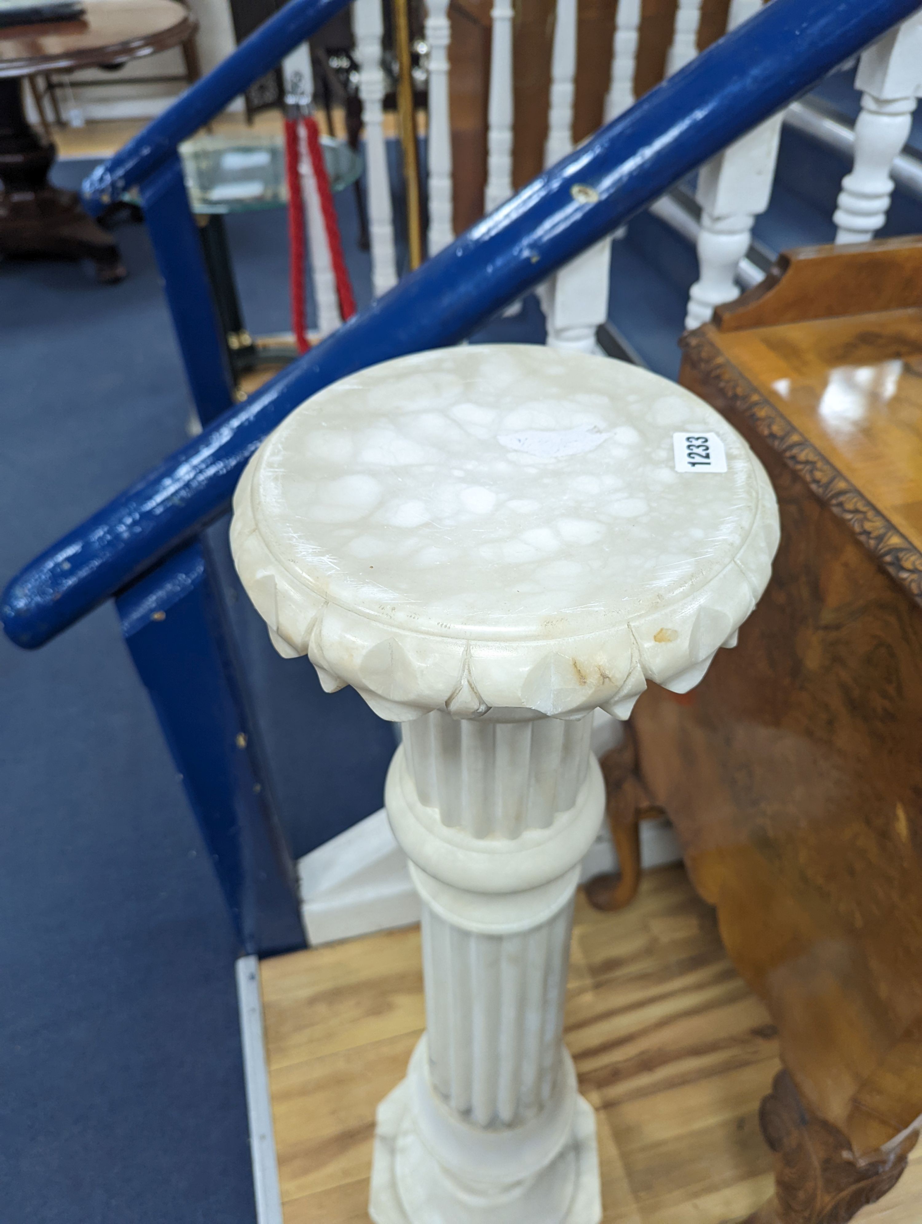 A carved alabaster pedestal on octagonal base, height 108cm